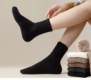 Detailed view of thick winter crew socks with soft plush loop interior for warmth.
