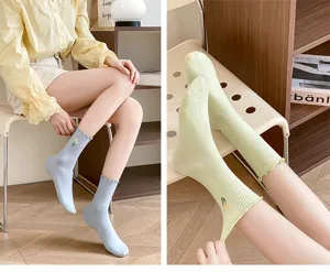 Women's mid-tube cotton socks featuring frilly lace edges and delicate small flower embroidery.