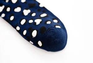 Detailed view of fashionable blue cotton socks featuring a chic black and white abstract pattern.