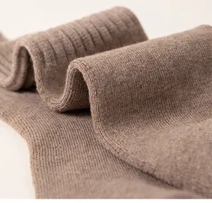 Close-up detail of thick thermal loop knit winter socks, soft texture and cozy ribbed cuff design.