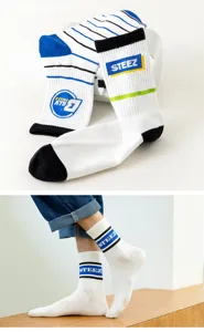 Detail view of winter men's mid-tube cotton socks featuring blue stripes and STEEZ logo.