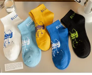 Detailed shot of trendy casual short socks in multiple colors featuring graffiti letter prints.