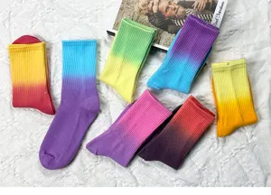 Colorful tie-dye gradient mid-tube socks flat lay detail view showing various bright hues.