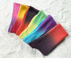 Detailed view of colorful gradient tie-dye mid-tube socks, soft cotton fabric texture