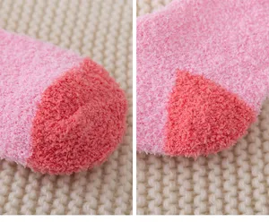 Soft coral fleece socks detail close-up, thick warm winter fuzzy sleep socks pink color.