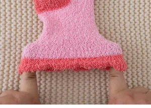 Close-up of cozy fuzzy coral fleece sock cuff showing stretchy elastic thick material.