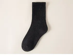 Detailed view of thick winter crew socks in dark grey, highlighting soft knitted texture.