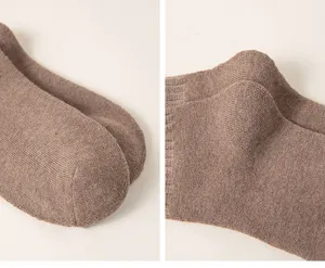 Close-up detail of thick ribbed brown terry socks, showing soft fleece fabric and texture.
