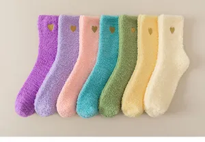 Coral fleece cozy winter socks detail featuring soft plush texture and cute gold heart embroidery.
