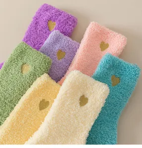 Soft coral fleece sleep socks for women featuring cute gold heart embroidery and warm fleece.