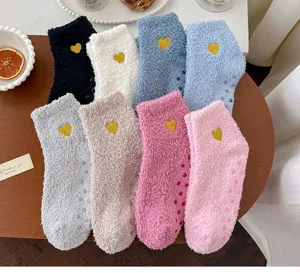 Cozy coral fleece women socks with cute heart embroidery and anti-slip grips for home sleep.
