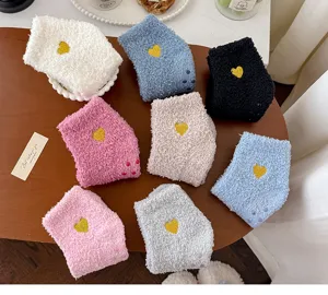 Cozy coral fleece fuzzy socks for women, cute heart embroidery anti-slip floor socks detail.