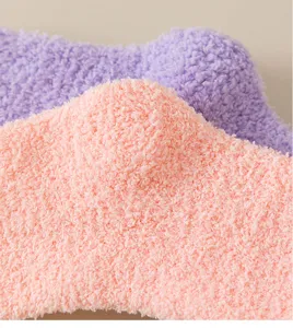 Close-up view of soft coral fleece socks detail, fluffy warm winter floor socks texture.
