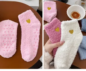 Detail shot of cute heart-embroidered coral fleece floor socks with anti-slip dots for women.
