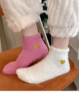 Soft coral fleece women socks with cute gold heart embroidery, cozy home floor socks for winter.