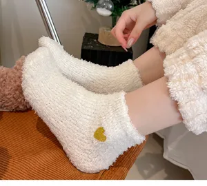 Cozy white fleece socks for women with cute gold glitter heart embroidery, soft winter home wear.