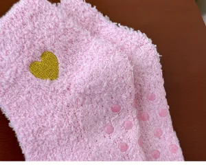 Pink coral fleece women socks with cute gold heart embroidery and anti-slip dots for home.