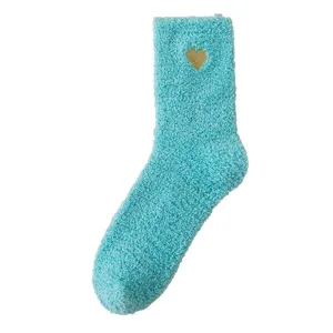 Cozy fuzzy fleece winter socks in light blue with gold heart accent, plush thermal sleep socks.