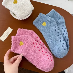 Coral fleece women socks with cute heart embroidery and non-slip dots for cozy home wear.