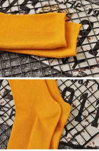 Solid yellow cotton mid-tube socks, breathable double-needle spring autumn women socks detail.