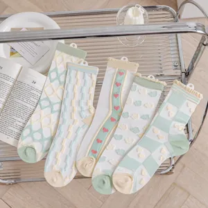 Detailed shot of Japanese style sheer mesh women socks with cute heart and grid patterns for summer.