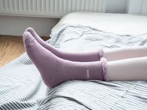 Cozy winter plush fleece-lined women socks detail shot with rolled edge and cozy embroidery.