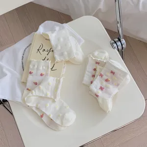 Sweet Japanese style white mid-tube socks featuring cute strawberry and bow patterns for women.