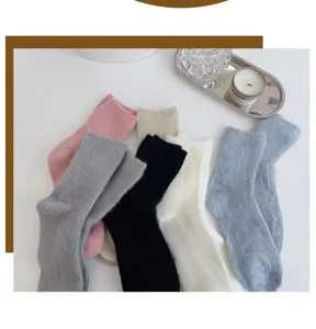 Fuzzy winter warm mid-calf socks detail shot, soft plush material in multiple solid colors.