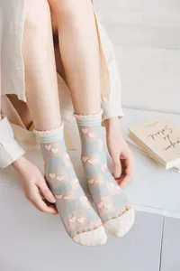 Detailed close-up view of sheer mesh summer socks featuring cute plaid and heart patterns.