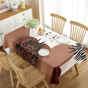 Detailed scene of modern boho abstract leaf tablecloth in cozy dining room setting.