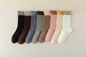 Detailed view of women's colorful mid-tube socks with contrasting layered cuffs.