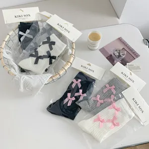 Detailed view of sweet Lolita bow mid-tube socks, featuring cute ribbon details in soft knit fabric.