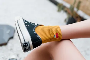 Japanese style women's mid-tube socks with cute rainbow heart embroidery for daily wear.