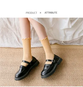 Detail view of sweet ruffle edge mid-tube socks paired with classic black shoes.