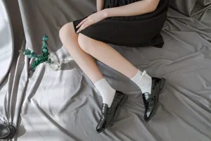 Close-up detail shot of Japanese JK Lolita mid-tube socks with white lace and cute bows.