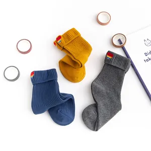 Detail of Japanese style women crew socks with embroidered rainbow heart and foldover cuff.