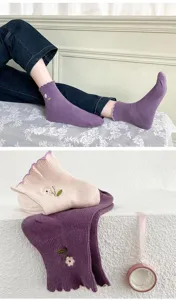 Sweet floral embroidered lettuce edge mid tube socks detail view showing soft ribbed fabric.