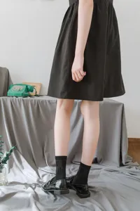 Detail view of black JK mid-tube socks, featuring delicate lace trim and lolita style.