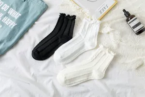 JK Lolita black white mid-tube socks with delicate lace ruffle trim for sweet daily wear.