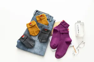 Japanese style ribbed mid-calf socks with rainbow heart embroidery and cuff design for girls.