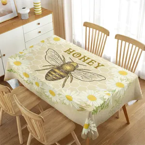 Detailed view of the bee and daisy pattern tablecloth, perfect for dining room decor.