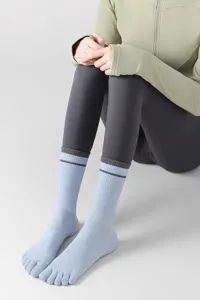 Detail view of light blue toe socks with split-toe design for yoga and pilates comfort.
