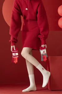 Red mid-tube socks set with cute cartoon embroidery, stylish knitted outfit for winter daily wear.