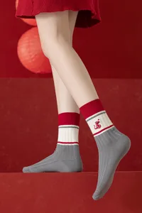 Year of the Snake red mid-tube socks, thick knit striped design with festive embroidery.