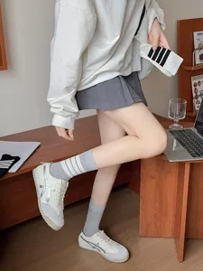 Detail view of Japanese JK style grey mid-tube socks with three stripes for daily wear.