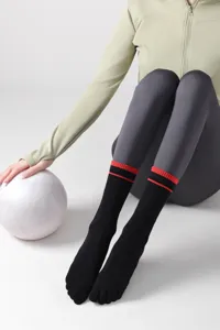Detailed shot of women's black mid-tube five-toe sports socks featuring red striped cuffs.