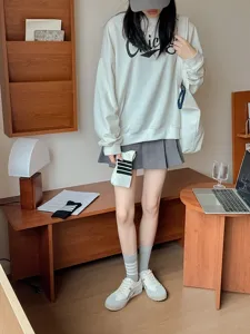 Detailed scene view of Japanese college style outfit featuring stylish socks and sweatshirt.