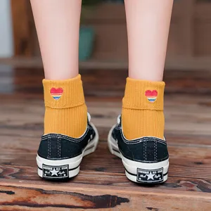 Japanese style yellow mid-tube cotton socks with cute rainbow heart embroidery and fold cuff.
