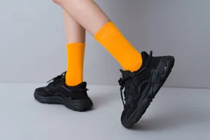 Colorful crew socks for women, bright orange mid-calf cotton socks, trendy streetwear style.