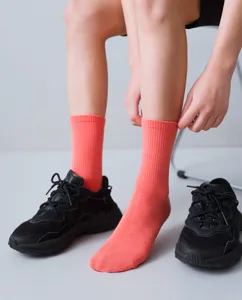 Comfortable coral pink mid-tube socks for women, perfect for daily wear and spring outfit.
